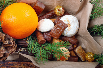 Delicious sweets, chocolates, cookies and oranges for gifts in  wooden box