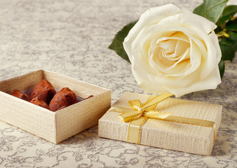 Beautiful white rose with golden gift box and chocolate truffles for Valentine's Day