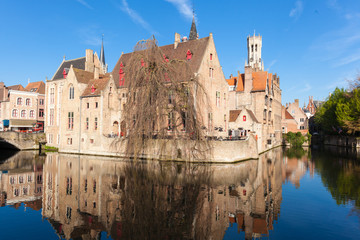 Rozenhoedkaai canal (Quai of the Rosary), and Belfort van Brugge’s Belfry Tower. Typical view of Bruges (Brugge), Belgium.