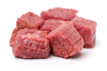 beef cubes with parsley on white background 