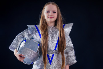 Astronaut girl with silver uniform and helmet studio black background