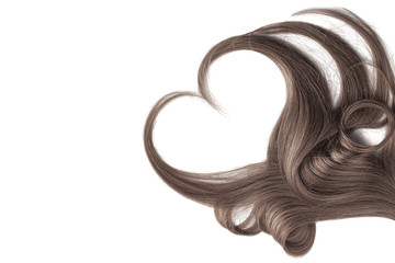 Brown hair in shape of heart, isolated on white background