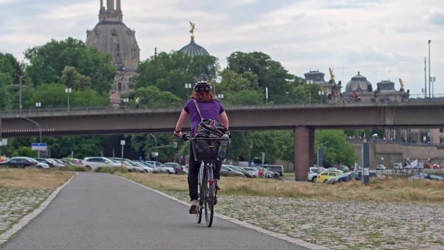 Tourist traveling by bike on the roads of the beautiful German city - Dresden.