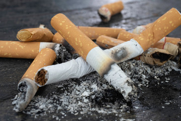 Cigarettes were burned and cigarettes were pumped.The World No Tobacco Day falls on May 31 of every year.Smoke cigarettes were smashed,Close-up shots On black wood floor.shallow focus effect..