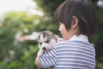 Cute asian child holding siberian husky