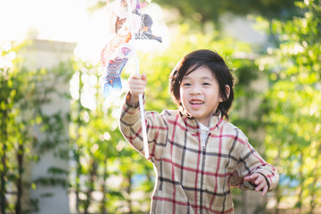 Cute Asian child holding koinobori