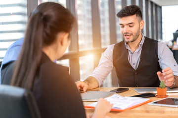 Businesspeople discussing together in conference room during meeting at office.