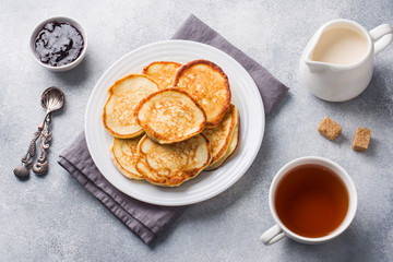 Cottage cheese pancakes with jam and tea. Concept healthy Breakfast.