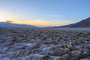 Death Valley, California / USA - May 24, 2019: Badwater Baseline in Death Valley California. Salt landscape in a National Park at sunset.