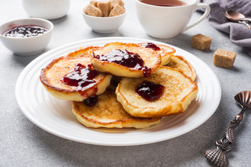 Cottage cheese pancakes with jam and tea. Concept healthy Breakfast.