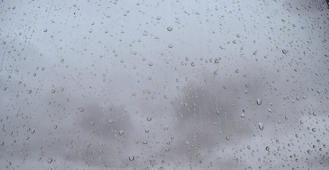 Raindrops on the window pane Atmospheric phenomenon expressed by high humidity and precipitation.