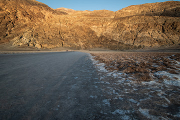 Death Valley, California / USA - May 24, 2019: Badwater Baseline in Death Valley California. Salt landscape in a National Park at sunset.
