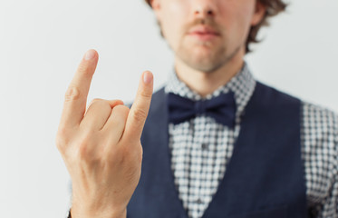 Man with beard in a bowtie with funny gesture