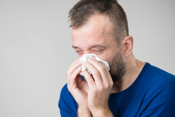 Man blowing nose