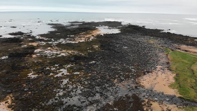 Aerial footage over Ytri Tunga beach located in Iceland. Shallow water with lots of sand and seagrass. Home of many seals.