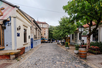 Fototapeta na wymiar Belgrade, Serbia - June 16, 2018. Historic place Skadarlija with shops, galleries, cafes, trees, cobbled lanes and alleys in downtown. Bohemian street with bars, cafes and graffiti.