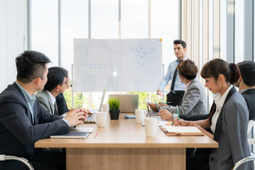 Businesspeople discussing together in conference room during meeting at office.
