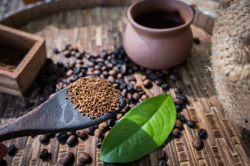 Roasted coffee beans in a spoon ready to drink.