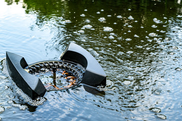 Skimmer floats on surface of water in pond. Close-up. Beautiful and clean pond. Skimmer collects...