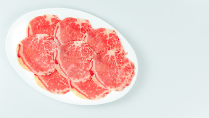 raw beef on a plate .