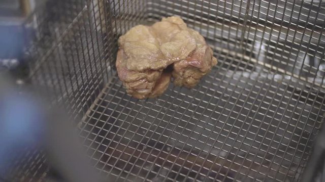 Getting fried chicken breast out of boiling oil