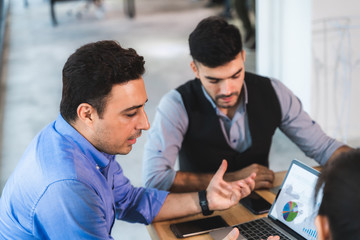 Businesspeople discussing together in conference room during meeting at office.