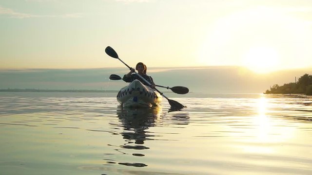 Young couple with kayak during sunset