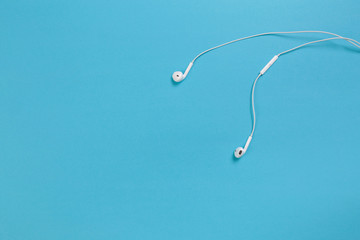 white headphones on blue background