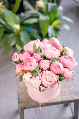 Pink peonies on the old grey table. Beautiful peony flower for catalog or online store. Floral shop concept . Beautiful fresh cut bouquet. Flowers delivery