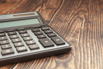 Modern calculator on a wooden table, business concept, close-up