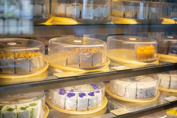 Cake tray in showcase glass display at store bakery pastry shop