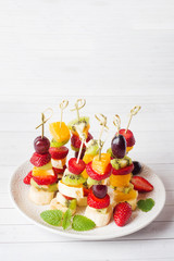 Fresh fruit on skewers. Concept buffet for a summer party. Copy space