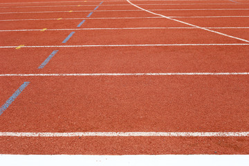 all-weather running track, rubberized artificial racing lane surface for track and field athletics, texture of white lines and curved in the stadium