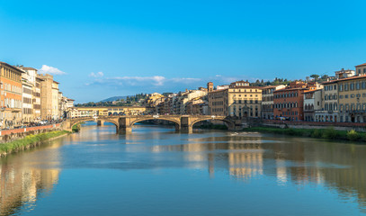 Florence, Tuscany / Italy: The Ponte Santa Trinita over the River Arno and the Ponte Vecchio in the distance