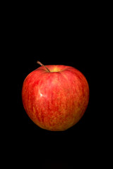 Fresh organic red apple isolated on black background.