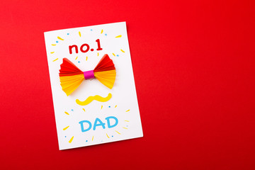 Happy fathers day sign on paper  laid on red  backround.
