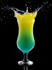 tropical cocktail splashing isolated on black