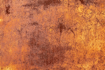 Rusty yellow-red textured metal surface. The texture of the metal sheet is prone to oxidation and corrosion. Textured background in grunge style