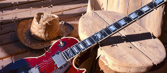 electric guitar behind the glass with water drops . closeup