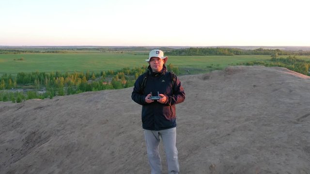 Konduki, Tula oblast, Russia. Aerial view of a man standing on a hill with a receding camera