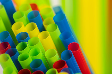 A closeup of different colored straws with blurry background