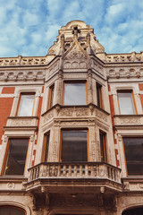 Fototapeta premium a building, richly decorated carved in stone in the historic center of the city of St. Petersburg, Russia