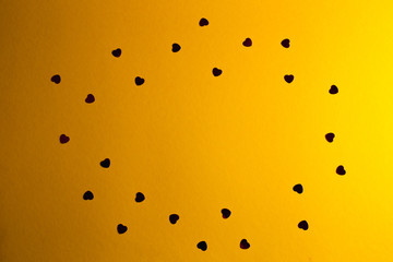 many little hearts, arranged on a yellow background
