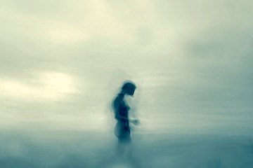 Sculpture of a nude girl walking among the clouds