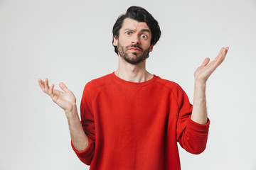 Fototapeta premium Confused young man isolated over white wall background.