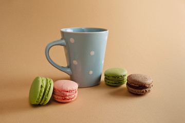 a cup of tea and macaron arranged in a beautiful composition on background