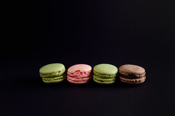 macaroon arranged in beautiful composition on a black background