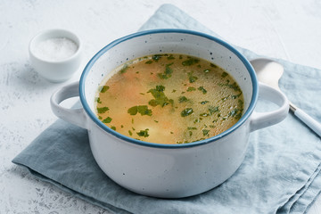 chicken soup, scandinavian homemade food with on blue stone table, side view