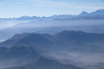 Naklejka na ściany i meble Misty blue Andean mountain landscape background