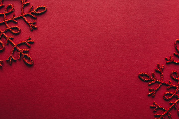Fototapeta na wymiar Gold snowflake on red background. New Year decoration.Minimal